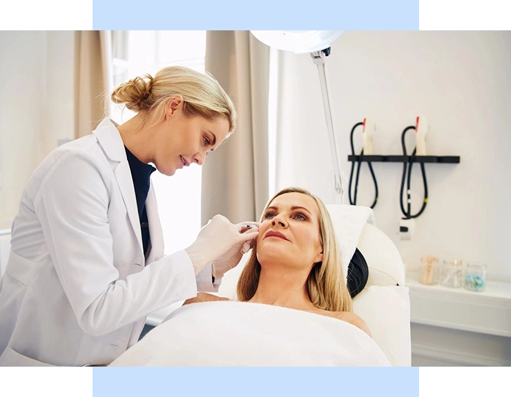 A woman is getting her face examined by an eye doctor.