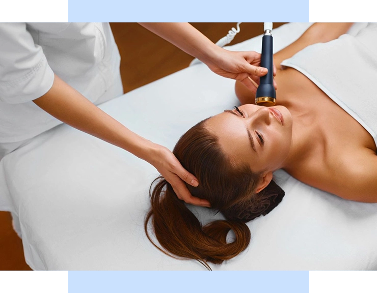 A woman getting her face cleaned by an esthetician.